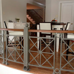 Upper level dining area with modern metal railing.
